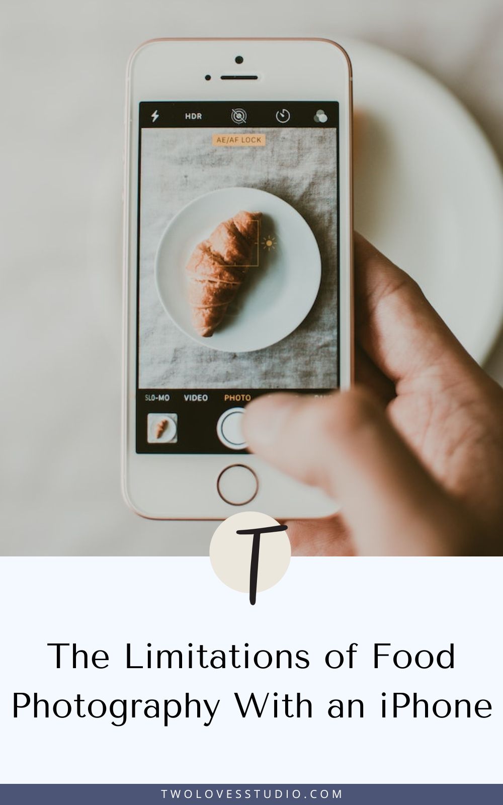 a food photographer with an iphone taking a photo of a crossaint.