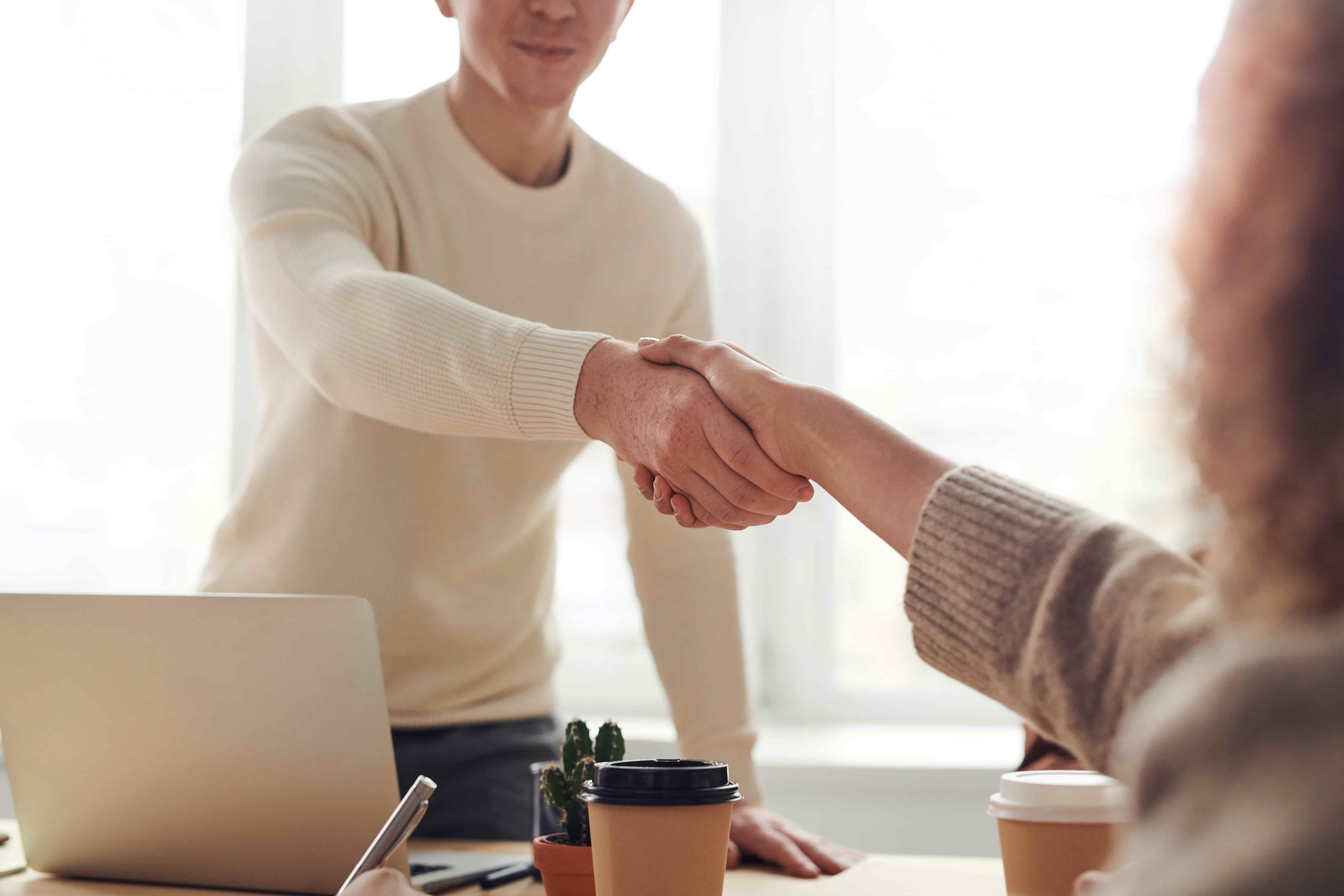 Man and woman shaking hands. How to handle free work. 