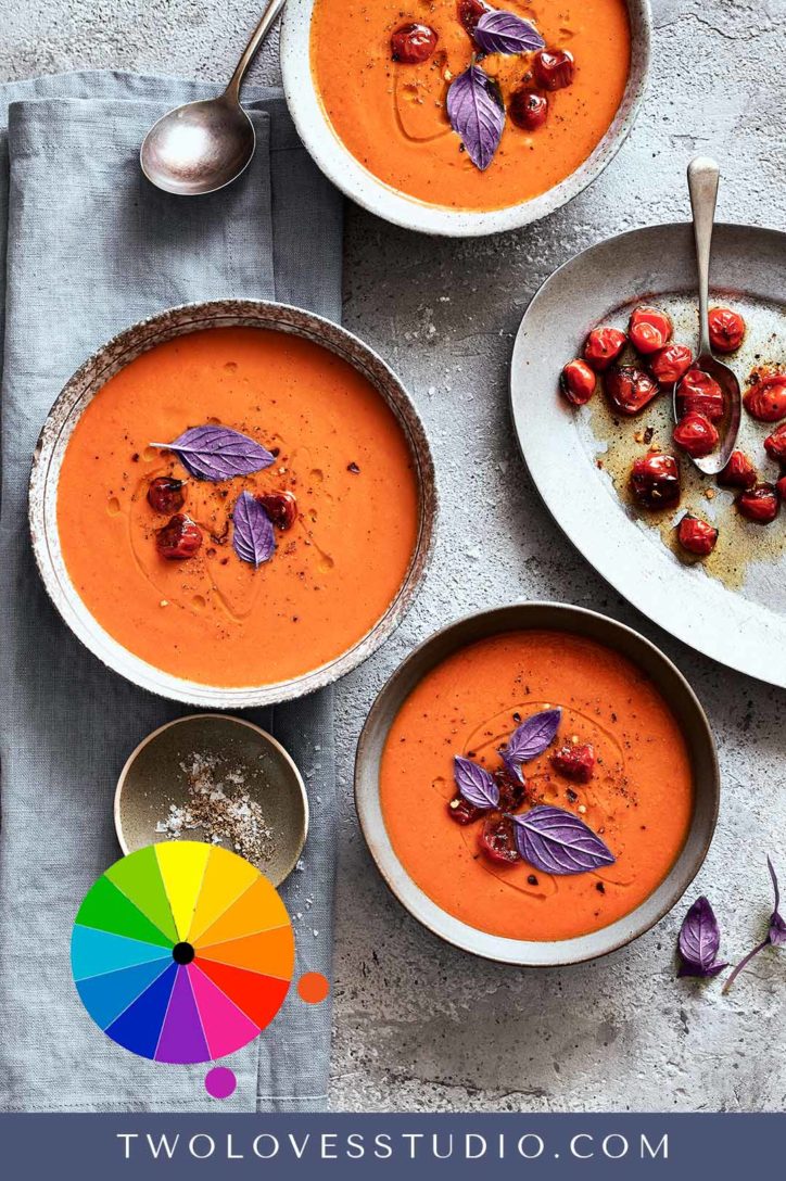 Red tomato soup with purple leaves on top. advanced color theories.