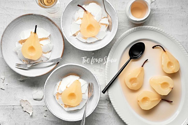 White background with pears in bowls. 