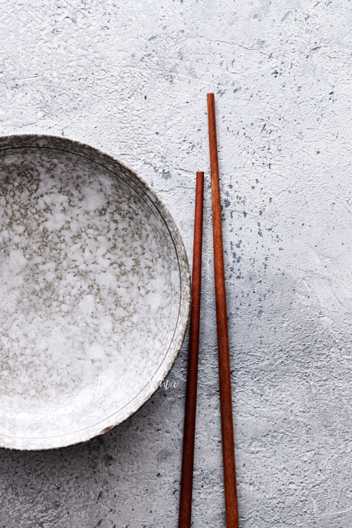 stone backdrop with Japanese bowl and chopsticks 