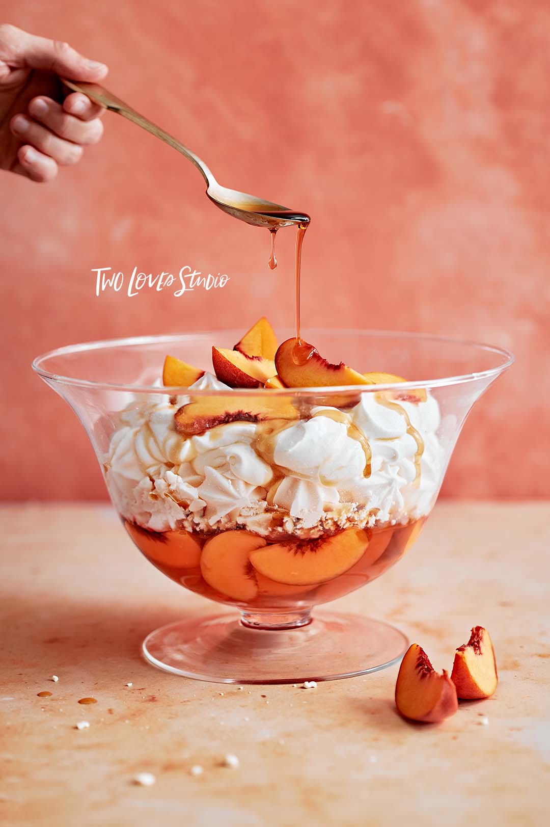 A peach meringue trifle with a drip of maple syrup.