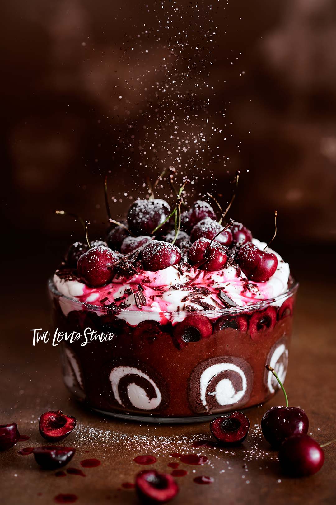 A black forest trifle with icing being sprinkled from above