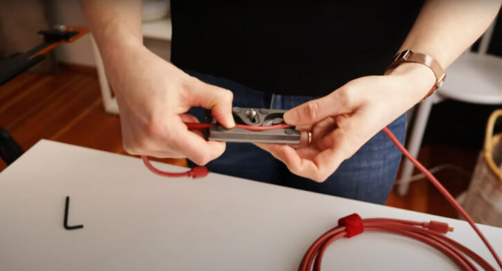 Demonstrating how to thread a tether cable into a tether block for tethering in food photography.