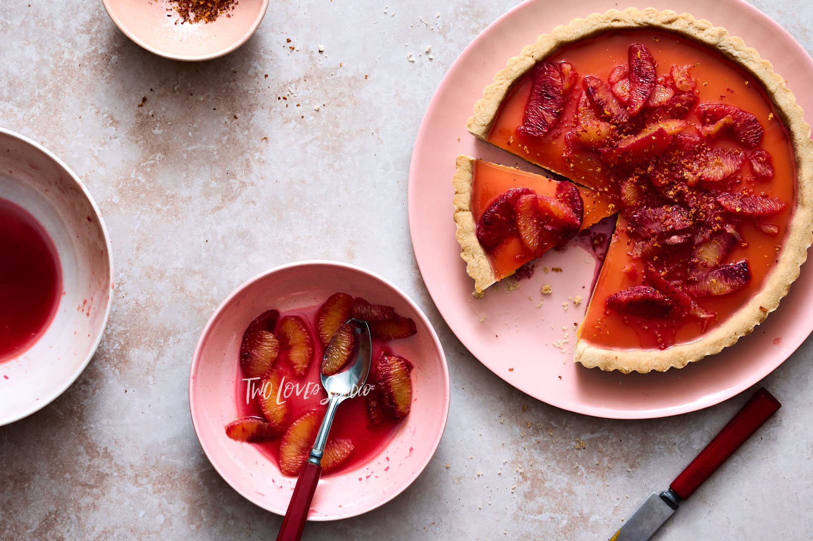 Blood orange tart with segments and  zest. Showing food photographers how to shoot food photography.
