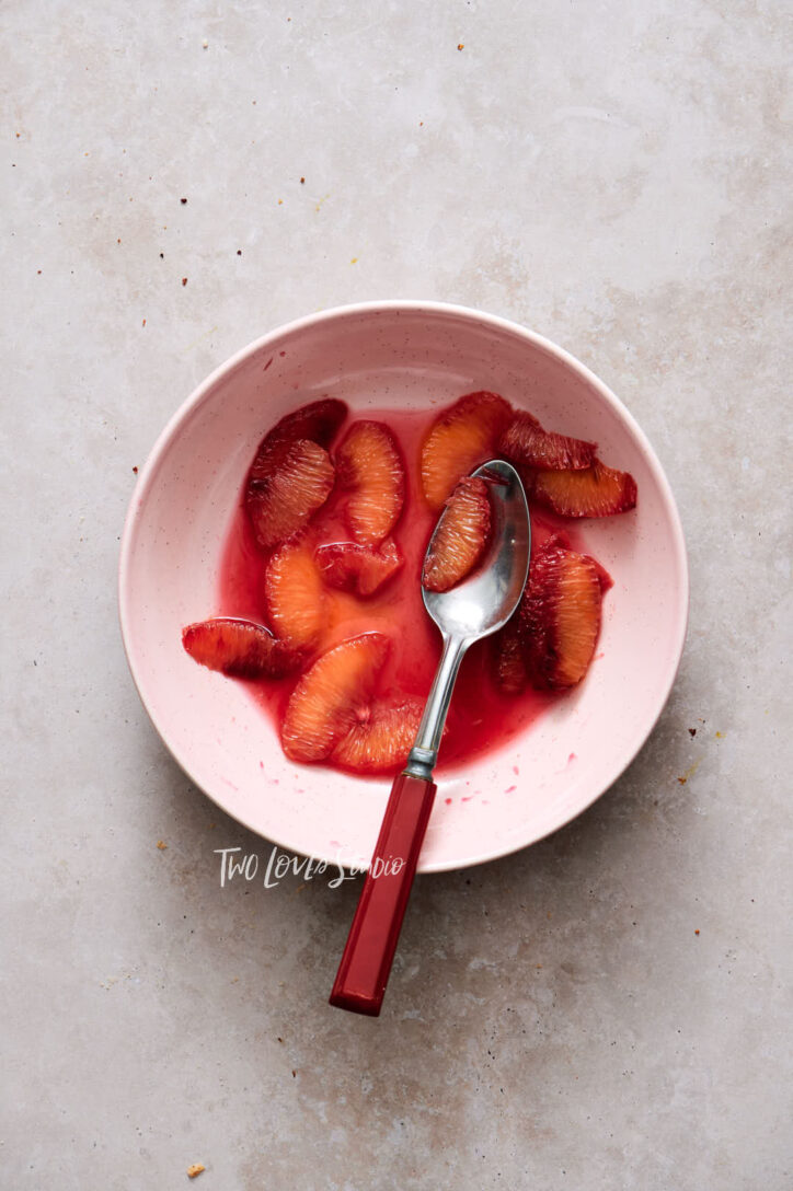 Blood orange segments in a pink bowl. Showing food photographers how to shoot food photography.