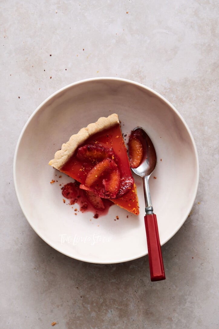 Blood orange tart slice with segments and  zest. Showing food photogarphers how to shoot food photography.